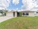 Single Gathering home with a well-maintained front yard and attached two-car garage at 2414 San Luis Rd, Holiday, FL 34691