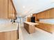 Spacious kitchen featuring an island, ample cabinet space, tile floors, and modern lighting fixtures at 2414 San Luis Rd, Holiday, FL 34691