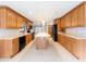 Large kitchen with a center island, marble backsplash, and lots of counter space at 2414 San Luis Rd, Holiday, FL 34691