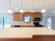 Well-lit kitchen with island, breakfast bar, stainless steel appliances, and plentiful cabinetry at 2414 San Luis Rd, Holiday, FL 34691