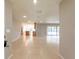 Open floor plan with tile flooring connecting the living and kitchen areas at 2414 San Luis Rd, Holiday, FL 34691