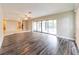 Spacious living room with wood floors and sliding glass doors leads to the outdoor living area at 2414 San Luis Rd, Holiday, FL 34691