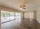 Open living area with wood flooring, sliding glass doors, and natural light at 2414 San Luis Rd, Holiday, FL 34691