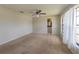 Large bedroom with carpet, neutral walls, fan, natural light from big window and ensuite access at 2414 San Luis Rd, Holiday, FL 34691
