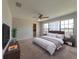 Staged bedroom with neutral color palette, carpet flooring, ceiling fan, and large windows for natural light at 2414 San Luis Rd, Holiday, FL 34691