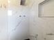 Modern shower featuring marble tiling, rain shower head, and a built-in shower niche at 2414 San Luis Rd, Holiday, FL 34691