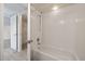 White tiled bathroom with shower and tub, with closet access at 2500 Winding Creek Blvd # G106, Clearwater, FL 33761