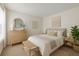 Inviting bedroom showcasing neutral colors, a decorative dresser, and a queen-size bed for a serene retreat at 2500 Winding Creek Blvd # G106, Clearwater, FL 33761