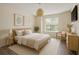 Comfortable bedroom featuring a large window, neutral tones, and stylish decor for a relaxing ambiance at 2500 Winding Creek Blvd # G106, Clearwater, FL 33761
