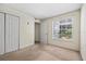 Bedroom with closet, window, and carpet flooring at 2500 Winding Creek Blvd # G106, Clearwater, FL 33761