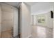 Well-lit bedroom with wood-look tile flooring, ensuite bathroom, closet, and a view of the outside at 2500 Winding Creek Blvd # G106, Clearwater, FL 33761