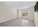Spacious bedroom features modern tile flooring and a large window at 2500 Winding Creek Blvd # G106, Clearwater, FL 33761