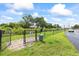 Community dog park with secure fencing, green space, and pet waste station, promoting a pet-friendly environment at 2500 Winding Creek Blvd # G106, Clearwater, FL 33761