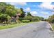 Community entrance sign with an American flag and well manicured landscaping at 2500 Winding Creek Blvd # G106, Clearwater, FL 33761