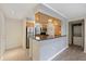 Cozy kitchen featuring stainless steel appliances, granite countertops, and wood cabinets with a washer/dryer hook up at 2500 Winding Creek Blvd # G106, Clearwater, FL 33761