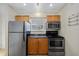 Efficient kitchen layout featuring stainless steel appliances, granite countertops, and wood cabinets at 2500 Winding Creek Blvd # G106, Clearwater, FL 33761