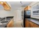 Well-lit kitchen with stainless steel appliances, granite countertops, and wood cabinets at 2500 Winding Creek Blvd # G106, Clearwater, FL 33761