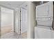 Hallway with a stacked washer and dryer unit at 2500 Winding Creek Blvd # G106, Clearwater, FL 33761
