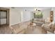 Cozy living room with neutral colored furniture, wood-look floors, and bright natural light from a large window at 2500 Winding Creek Blvd # G106, Clearwater, FL 33761