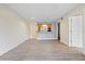 Open concept living room with wood-look flooring and a kitchen view creates a seamless, modern living space at 2500 Winding Creek Blvd # G106, Clearwater, FL 33761