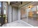 Screened-in patio with sliding glass doors and concrete flooring, and gray painted walls and a door at 2500 Winding Creek Blvd # G106, Clearwater, FL 33761