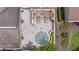 Aerial view of a community spa area, featuring lounge chairs, plants, and pergola at 2500 Winding Creek Blvd # G106, Clearwater, FL 33761