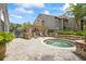 Relaxing hot tub and lounge area with pavers, perfect for outdoor enjoyment in a quiet community at 2500 Winding Creek Blvd # G106, Clearwater, FL 33761