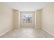 The sunlit bedroom features ceramic tile floors and plenty of natural light from a large window at 2500 Winding Creek Blvd # I106, Clearwater, FL 33761