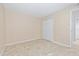 Spare bedroom with a tile floor and a closet with folding doors at 2500 Winding Creek Blvd # I106, Clearwater, FL 33761