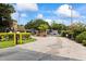 Secured community gate with brick entry, lush landscaping, and controlled access for resident privacy at 2500 Winding Creek Blvd # I106, Clearwater, FL 33761