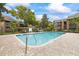 Inviting community pool with lounge chairs, umbrellas, and well-maintained surroundings at 2500 Winding Creek Blvd # I106, Clearwater, FL 33761