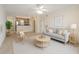 Inviting living room featuring a ceiling fan, sofa, and opening to the kitchen at 2500 Winding Creek Blvd # I106, Clearwater, FL 33761