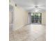 Open-concept living room featuring sliding glass doors, tile flooring, and ample space at 2500 Winding Creek Blvd # I106, Clearwater, FL 33761