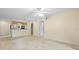 Bright living room featuring tile floors, a ceiling fan, and an open floor plan at 2500 Winding Creek Blvd # I106, Clearwater, FL 33761