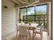 Charming screened patio with dining set and ceiling fan at 2500 Winding Creek Blvd # I106, Clearwater, FL 33761