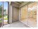 The screened patio features a sliding glass door to the home interior and outdoor space at 2500 Winding Creek Blvd # I106, Clearwater, FL 33761