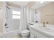 Bathroom featuring a shower-tub combo with tile surround, a white vanity, and a large mirror at 252 Arbor Woods Cir, Oldsmar, FL 34677