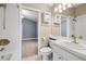 Bathroom featuring a tub with shower, a toilet, and a white vanity, connected to a bedroom at 252 Arbor Woods Cir, Oldsmar, FL 34677