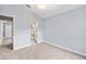 Carpeted bedroom with light blue walls, white trim, and a doorway leading to a bathroom at 252 Arbor Woods Cir, Oldsmar, FL 34677