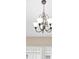 Elegant chandelier lighting fixture with frosted shades and decorative metalwork at 252 Arbor Woods Cir, Oldsmar, FL 34677