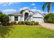 Beautiful single-story home with lush landscaping and a well-maintained lawn at 252 Arbor Woods Cir, Oldsmar, FL 34677