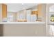 Open kitchen featuring a breakfast bar, white appliances, and ample cabinet space at 252 Arbor Woods Cir, Oldsmar, FL 34677