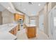 Bright kitchen with an island, white appliances, light wood cabinets and tile flooring at 252 Arbor Woods Cir, Oldsmar, FL 34677