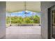 Spacious screened-in lanai with a serene view of the backyard and a ceiling fan at 252 Arbor Woods Cir, Oldsmar, FL 34677