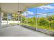 Relaxing screened lanai with beautiful views of the surrounding landscape and blue skies at 252 Arbor Woods Cir, Oldsmar, FL 34677