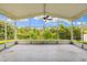 Screened lanai showcasing scenic views of lush greenery and blue skies at 252 Arbor Woods Cir, Oldsmar, FL 34677
