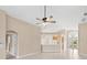 Spacious living area with neutral tones, tile floors, ceiling fan, and an open layout at 252 Arbor Woods Cir, Oldsmar, FL 34677