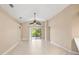 Bright living room featuring tile floors, ceiling fan, and sliding glass doors to lanai at 252 Arbor Woods Cir, Oldsmar, FL 34677