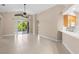 Bright open living area with tile flooring, sliding glass doors to a screened lanai, and natural light at 252 Arbor Woods Cir, Oldsmar, FL 34677