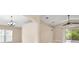 Open living room featuring tile floors, a ceiling fan, and sliding glass doors to the lanai at 252 Arbor Woods Cir, Oldsmar, FL 34677